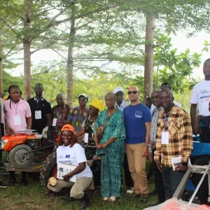 Beneficiaries of the seeds and agri-machines posed along with project implementing partners.