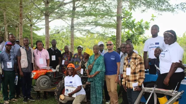 Beneficiaries of the seeds and agri-machines posed along with project implementing partners.